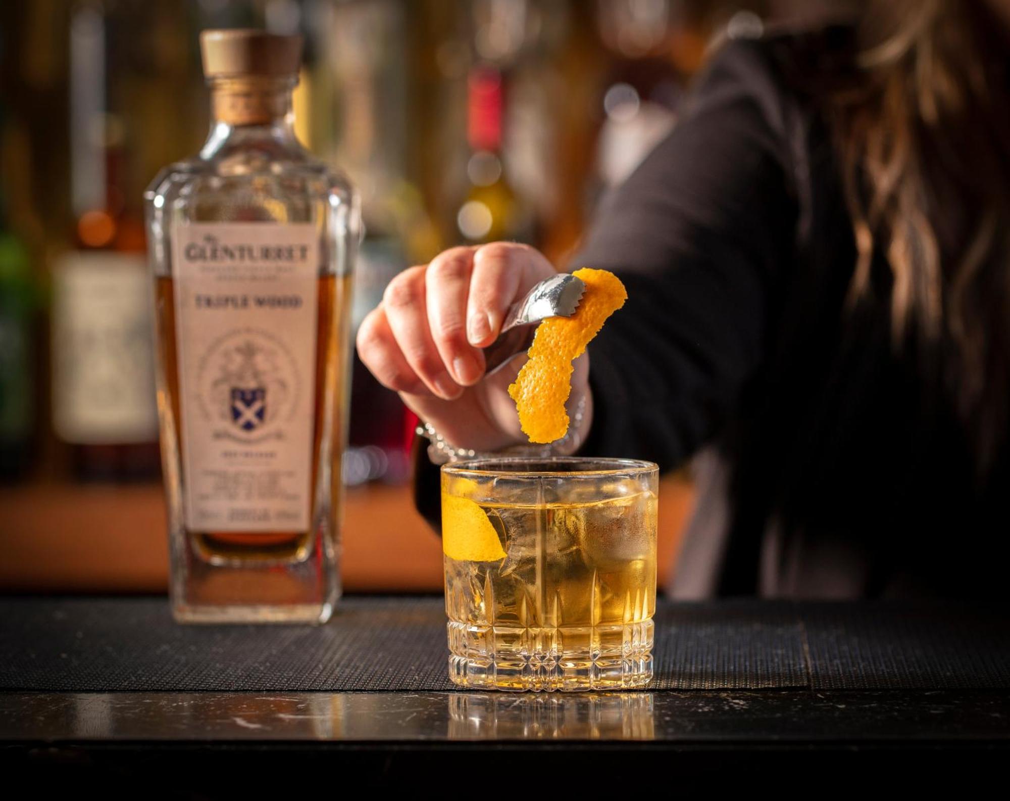 Schloss Roxburghe, Part Of Destination By Hyatt Exteriör bild A bartender adding a lemon twist to a glass of GINfinity